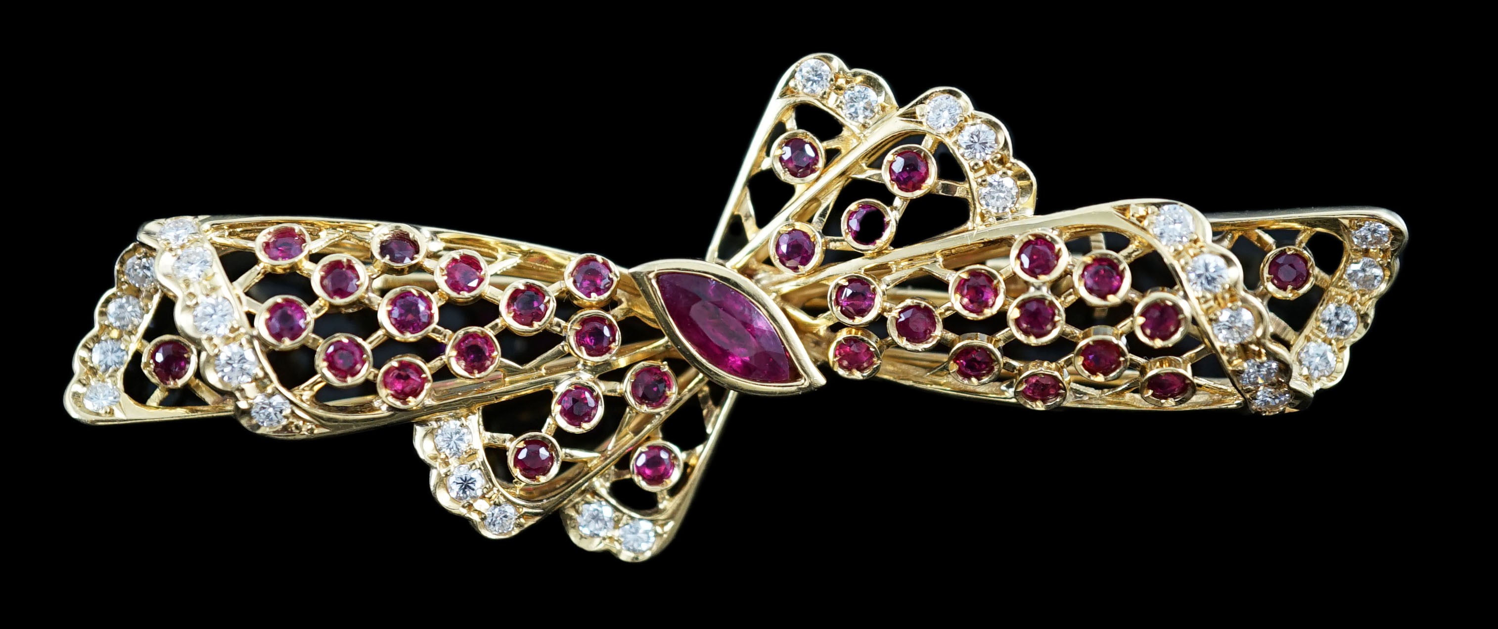 A mid to late 20th century pierced 18ct gold, ruby and diamond set ribbon bow brooch